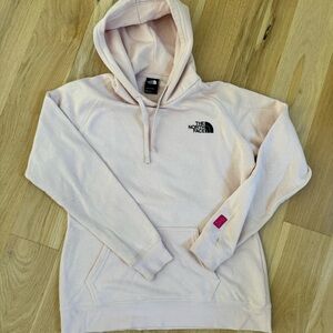 Pink North face breast cancer awareness logo. Size medium.